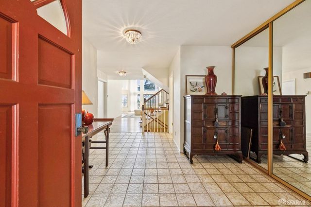a view of living room kitchen and entryway