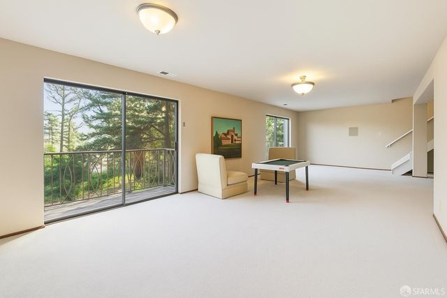 a view of a livingroom with furniture and floor to ceiling window