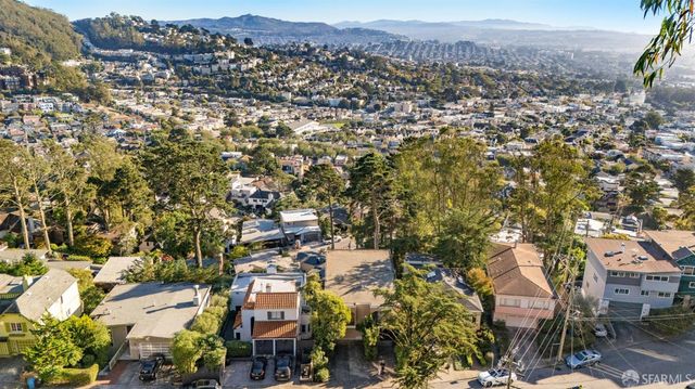 an aerial view of residential houses with city view