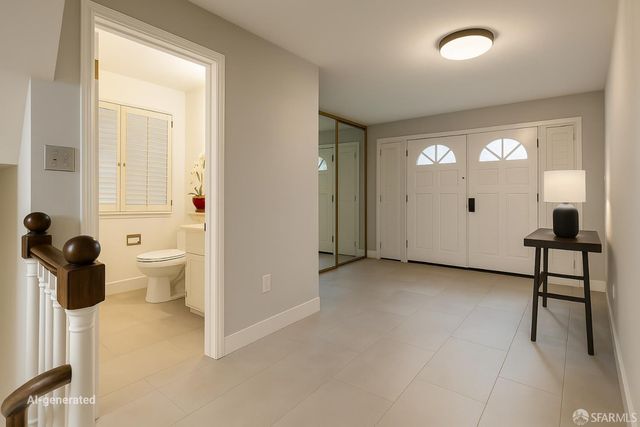 a view of a room that has a large window and chair