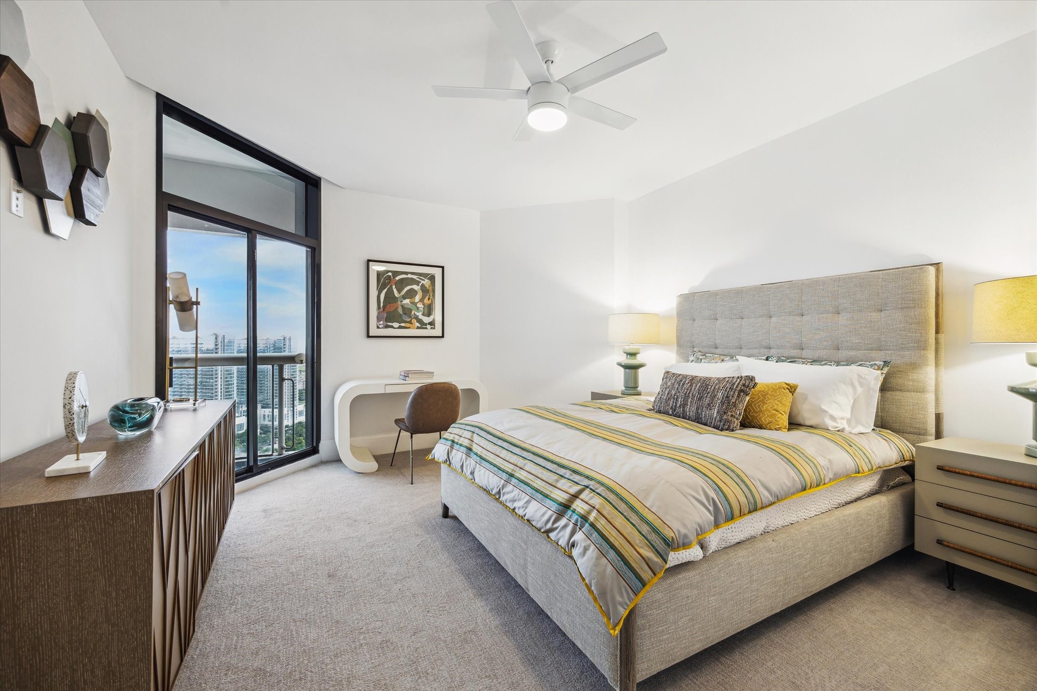 1701 Hermann Drive, Unit 30D Houston, TX 77004 - Photo 11 of 32 a bedroom with a bed and ceiling fan