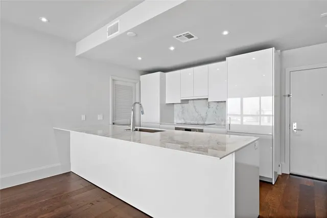 a kitchen with a sink window and cabinets