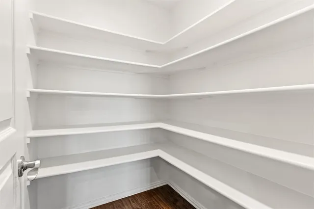 a view of an empty room with a ceiling fan