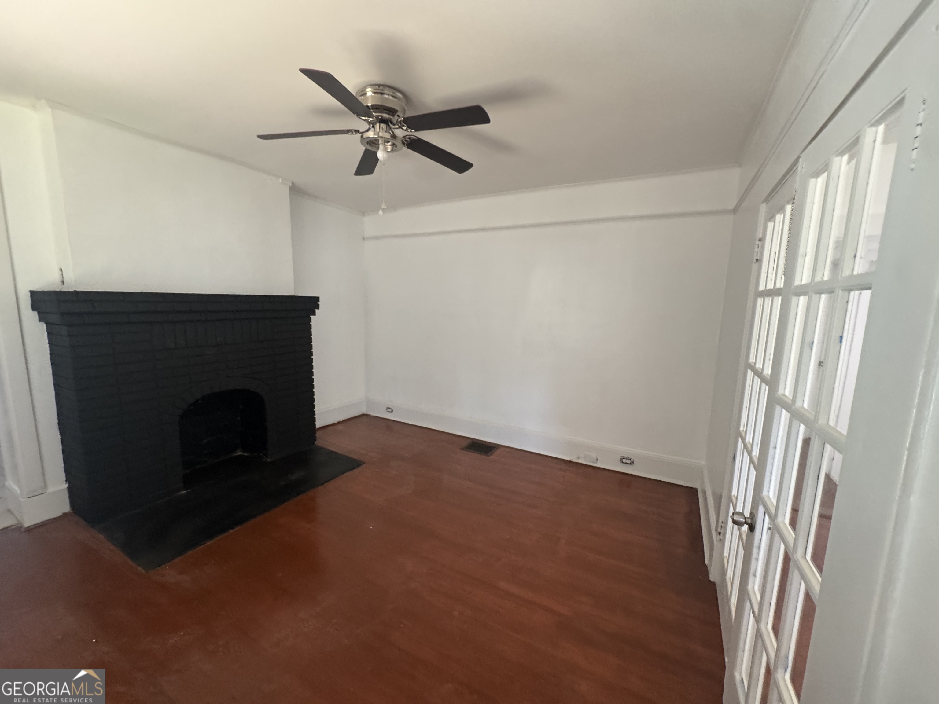 415 Hopkins Street Southwest Atlanta, GA 30310 - Photo 12 of 12 a view of a livingroom with a fireplace and a window