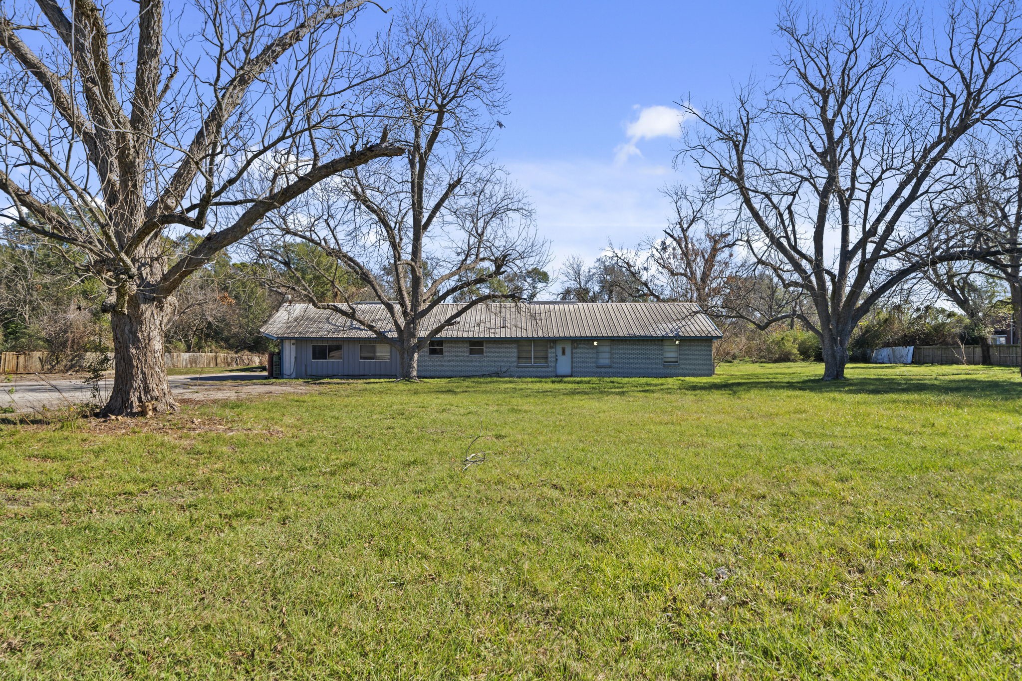 8438 Windfern Road Houston, TX 77040 - Photo 5 of 22 a house with trees in front of it