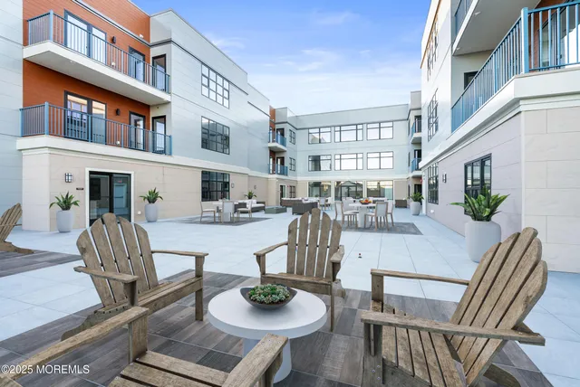 a view of a patio with dining table and chairs