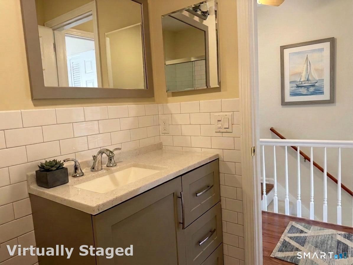 116 Commerce Street, Unit 5 Clinton, CT 06413 - Photo 14 of 18 a bathroom with a sink and a mirror