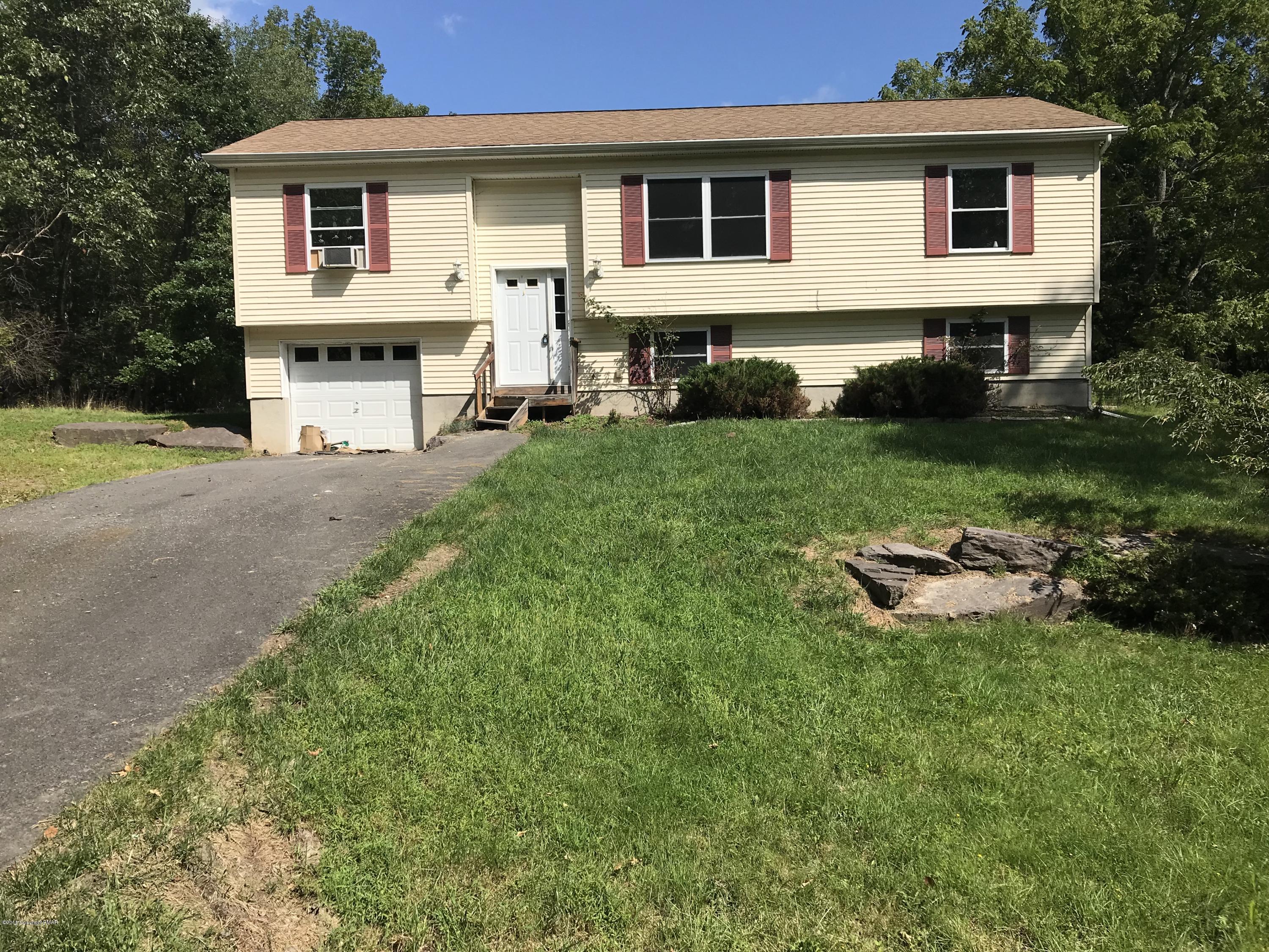 157 Magic Mountain Road Henryville, PA 18332 - Photo 18 of 29 a front view of a house with a yard and trees
