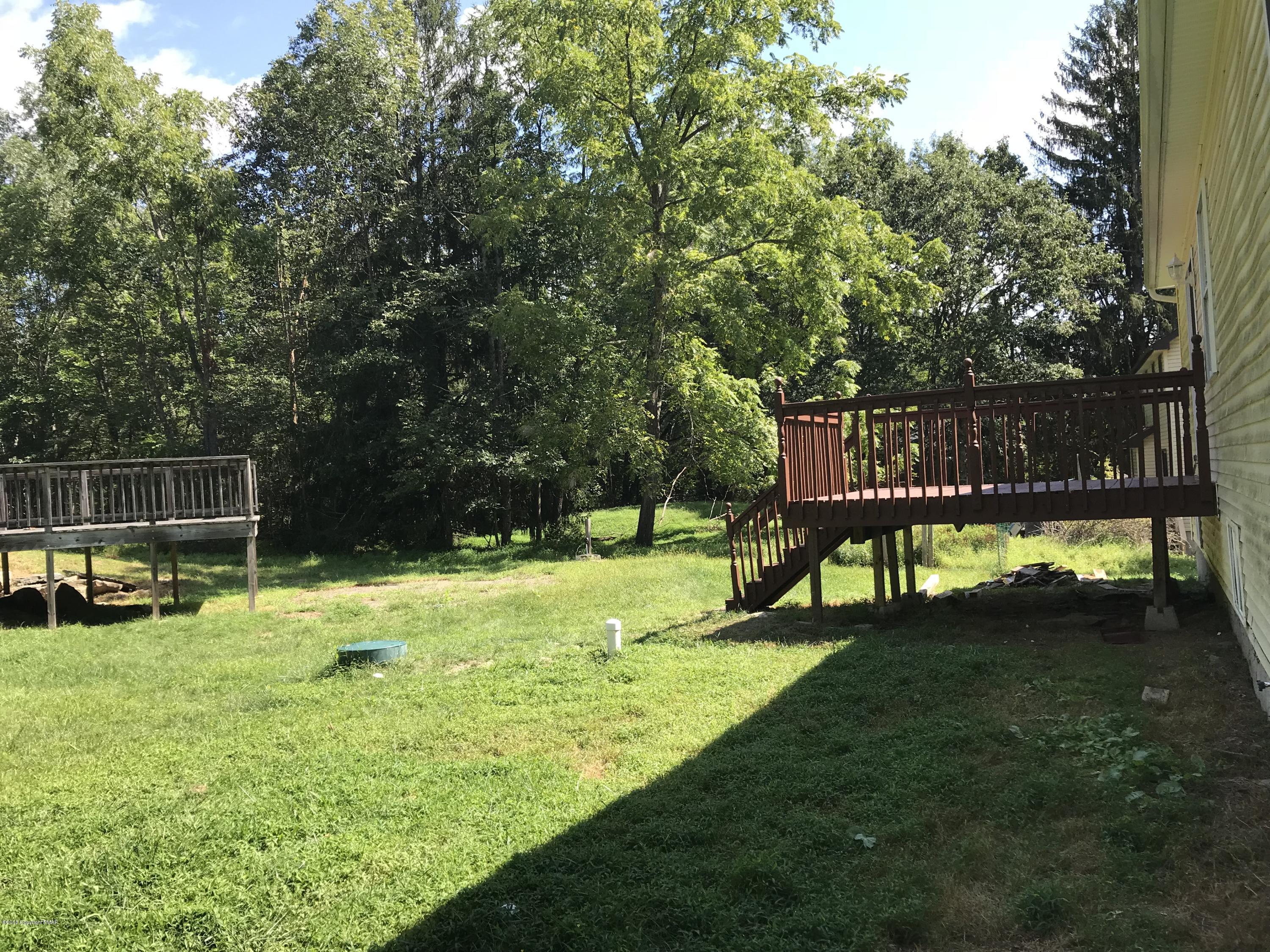 157 Magic Mountain Road Henryville, PA 18332 - Photo 19 of 29 a view of a backyard with sitting area