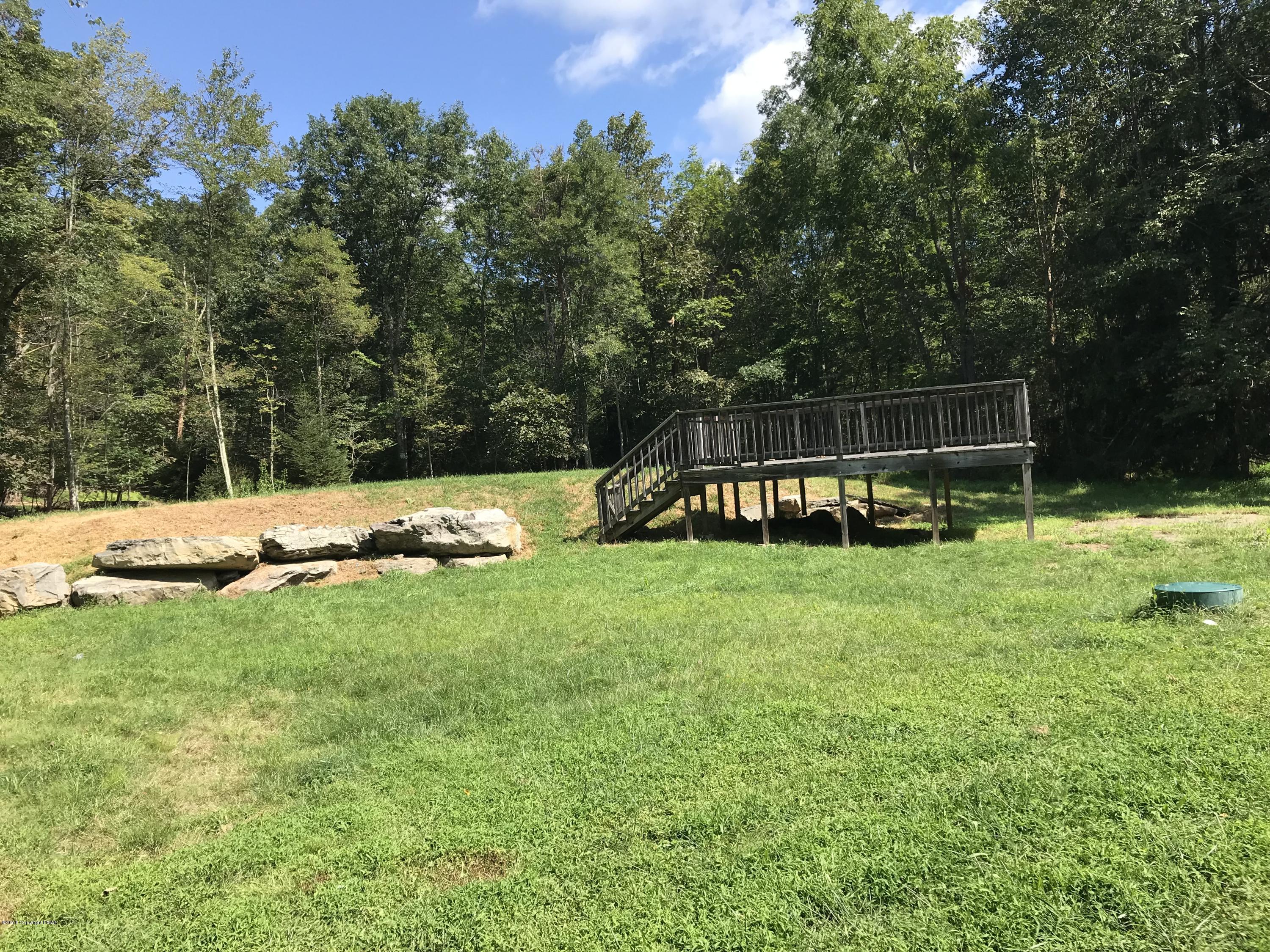 157 Magic Mountain Road Henryville, PA 18332 - Photo 21 of 29 a view of a backyard with a garden