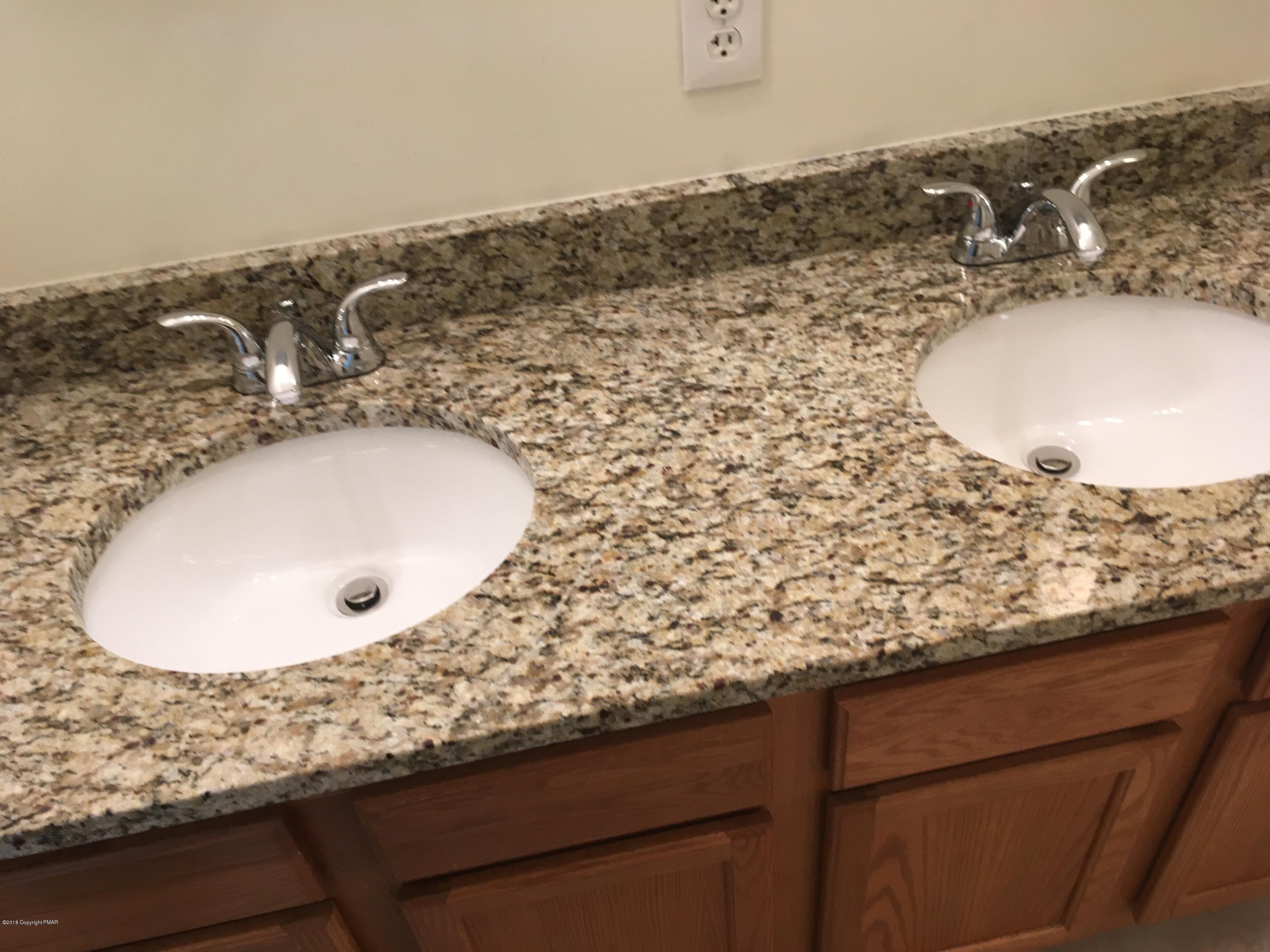 157 Magic Mountain Road Henryville, PA 18332 - Photo 23 of 29 a bathroom with a granite countertop sink and a mirror