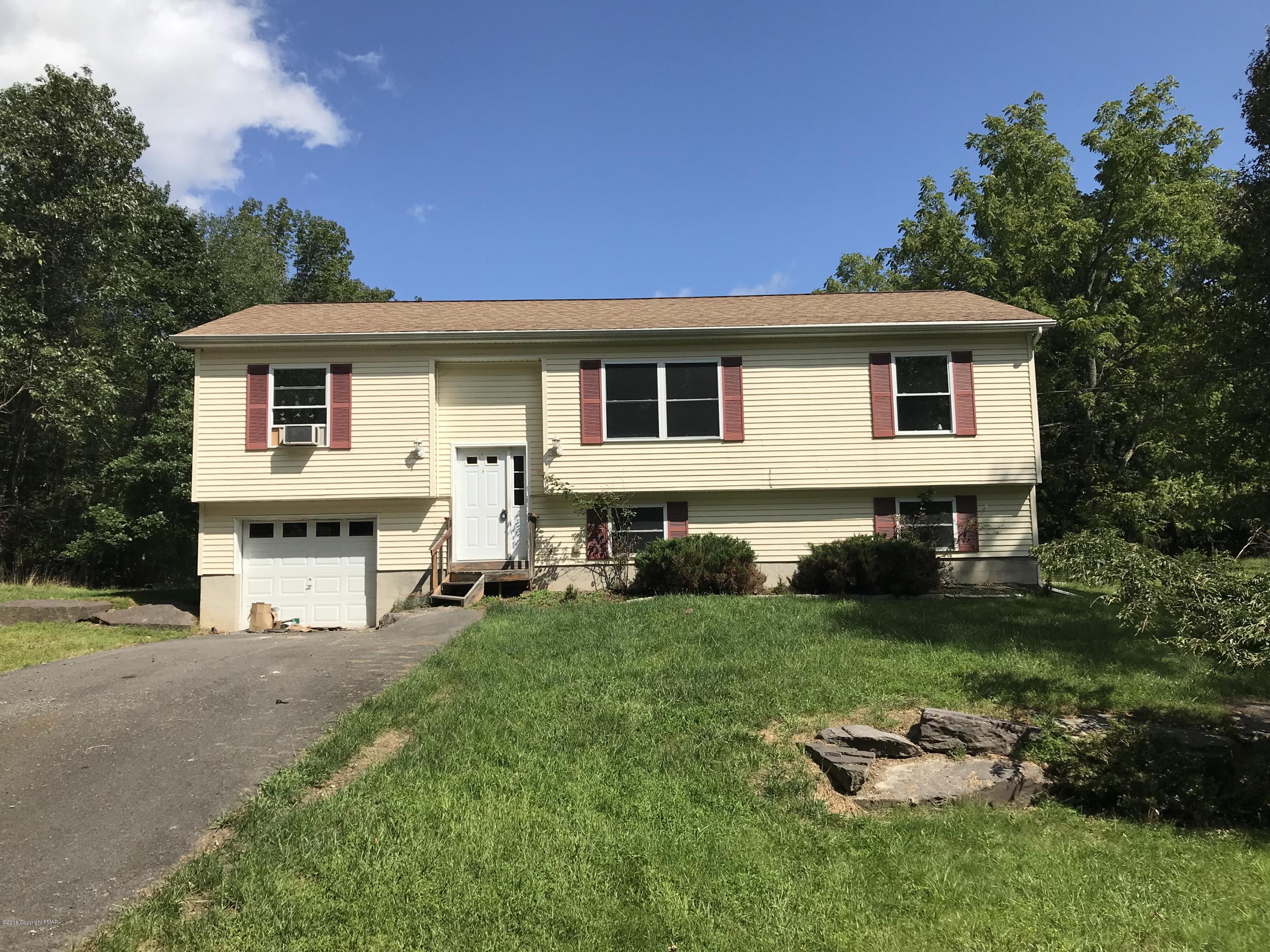 157 Magic Mountain Road Henryville, PA 18332 - Photo 25 of 29 a front view of a house with a garden