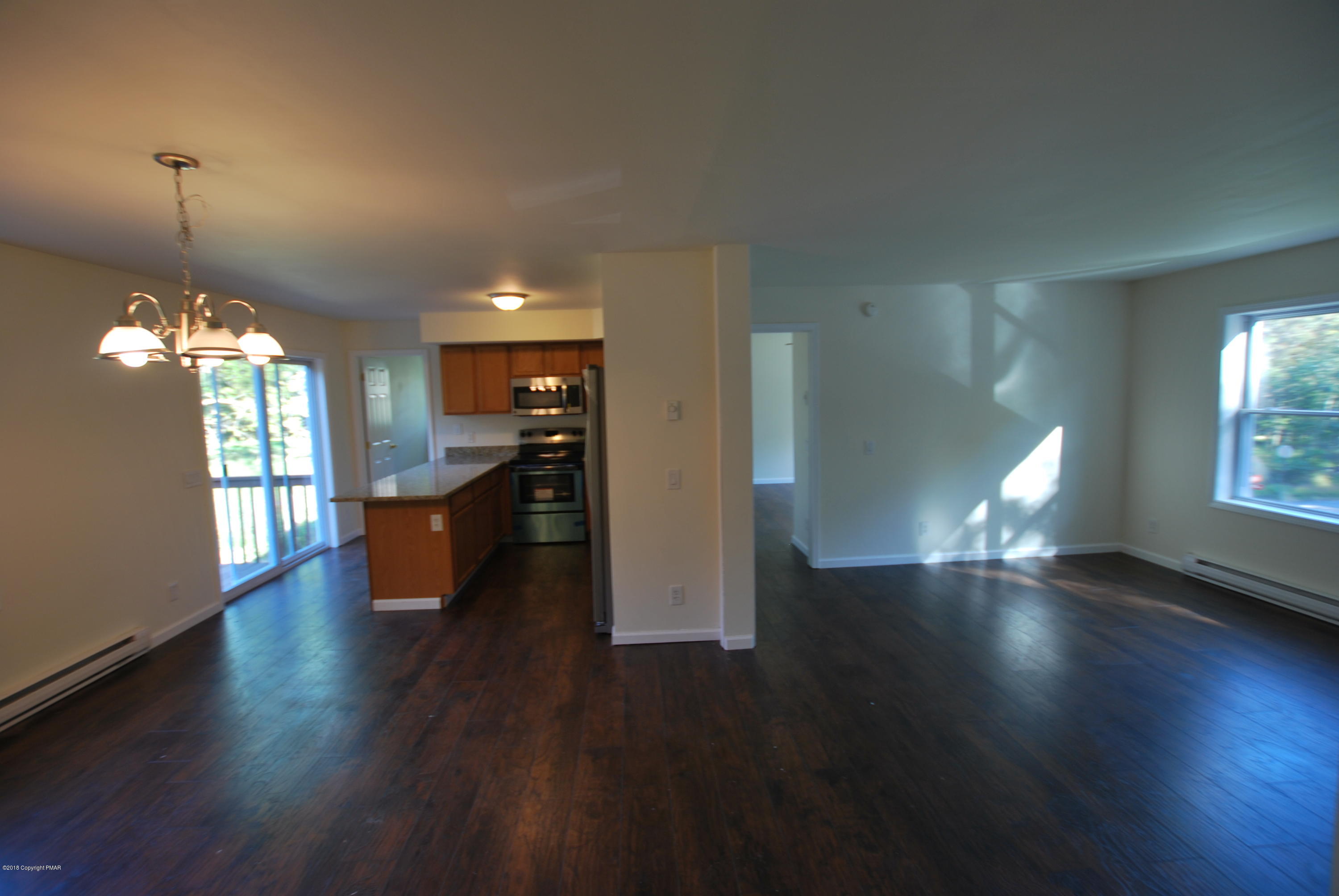 157 Magic Mountain Road Henryville, PA 18332 - Photo 4 of 29 a view of a living room and kitchen with wooden floor