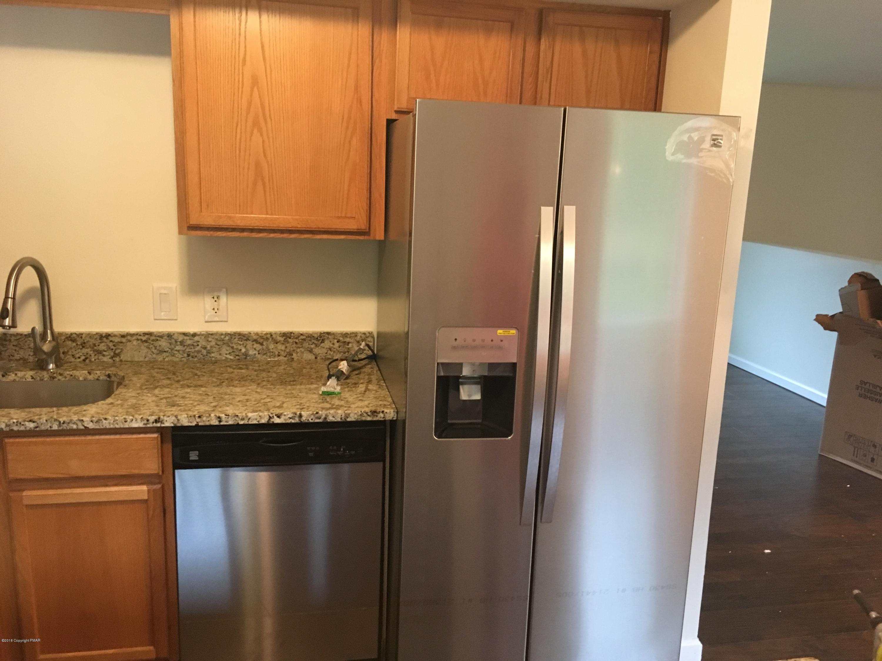 157 Magic Mountain Road Henryville, PA 18332 - Photo 6 of 29 a white refrigerator freezer sitting in a kitchen