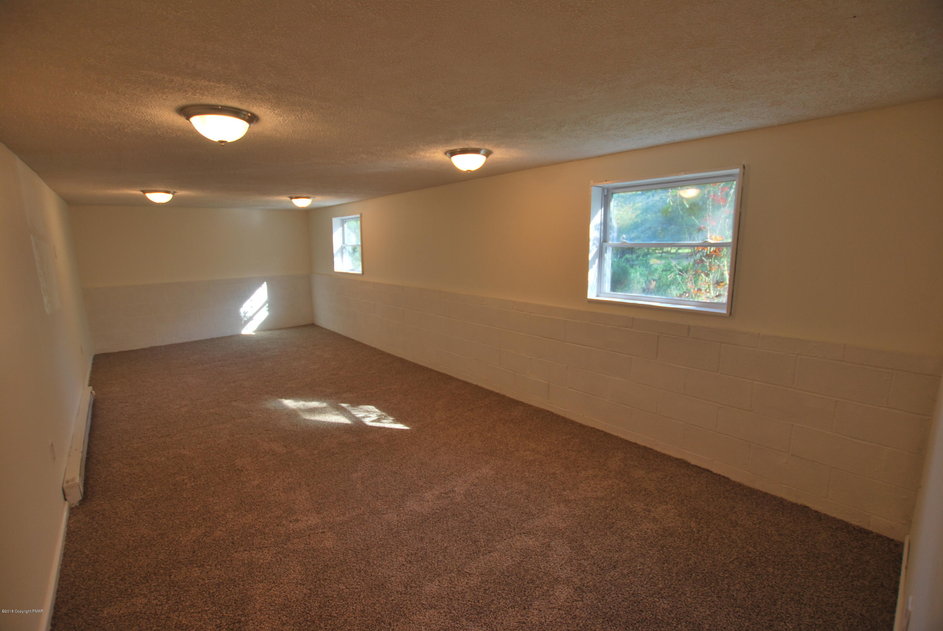157 Magic Mountain Road Henryville, PA 18332 - Photo 10 of 29 a view of an empty room with a window