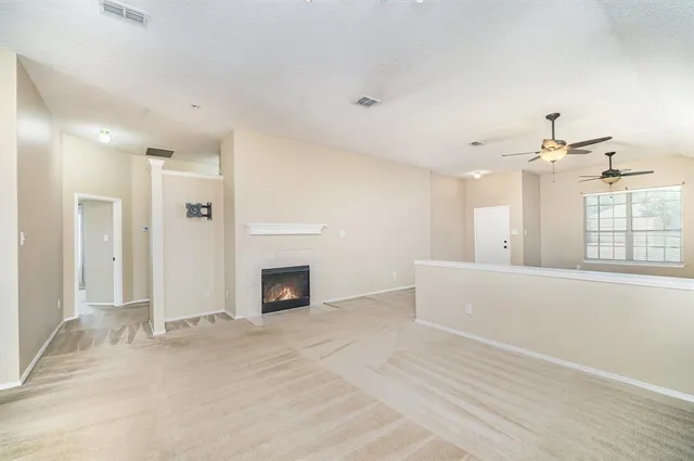 wooden floor in an empty room with a fireplace