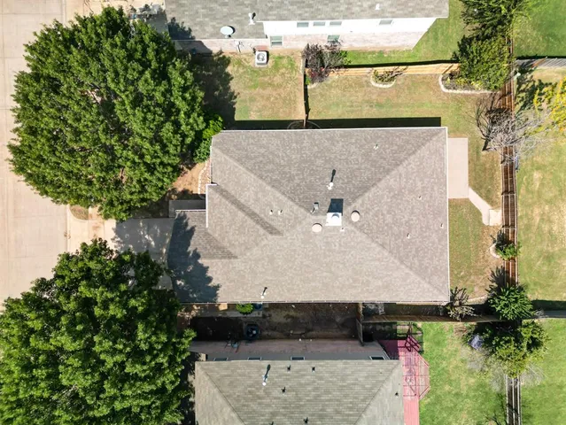 a view of a white house with a yard