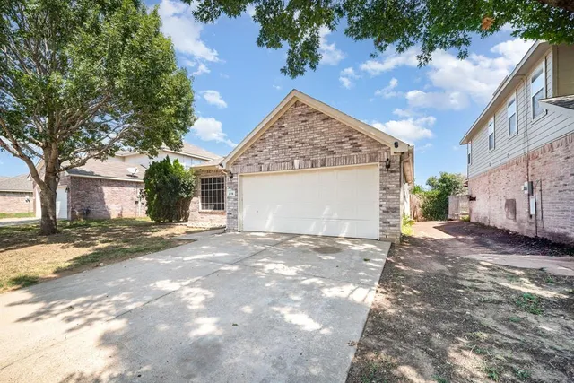 a view of a house with a yard and garage