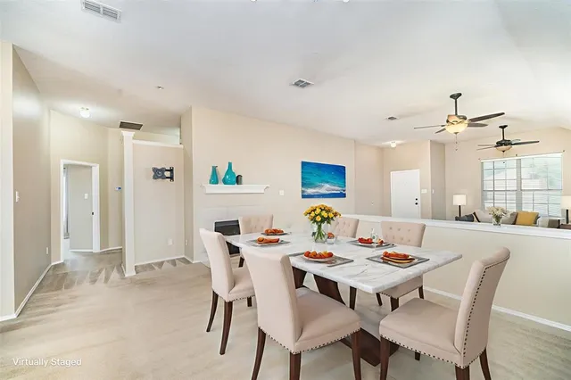 a dining room with a wooden table and chairs