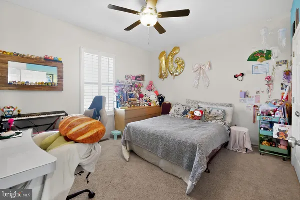 a bedroom with bed and a chandelier