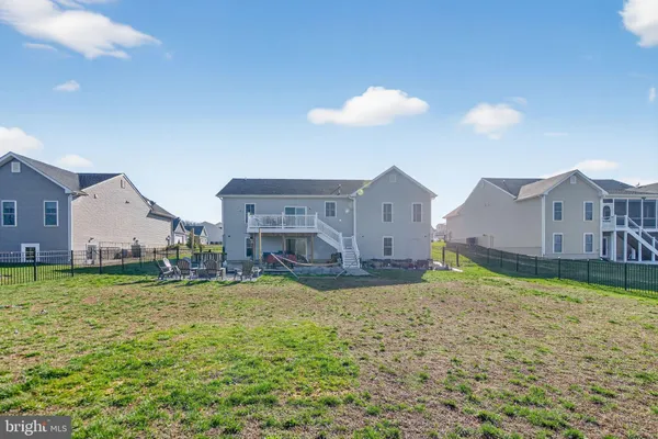 a view of a house with a yard and sitting area
