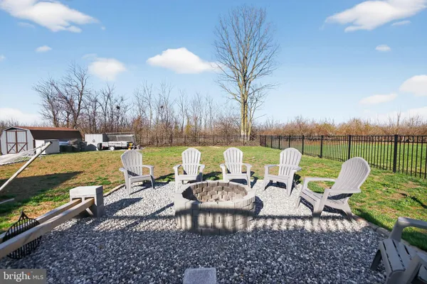 a view of a chairs and table in patio
