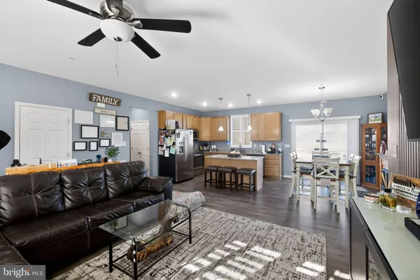 a living room with furniture kitchen view and a dining table