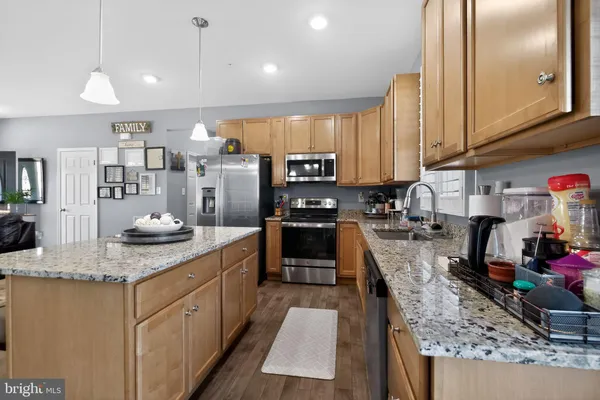 a kitchen with stainless steel appliances granite countertop a sink counter space cabinets and a counter space