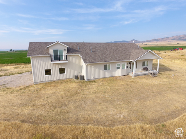 19502 South Olson Road Downey, ID 83234 - Photo 56 of 64 View of front facade with a shingled roof, a rural view, a porch, and a mountain view