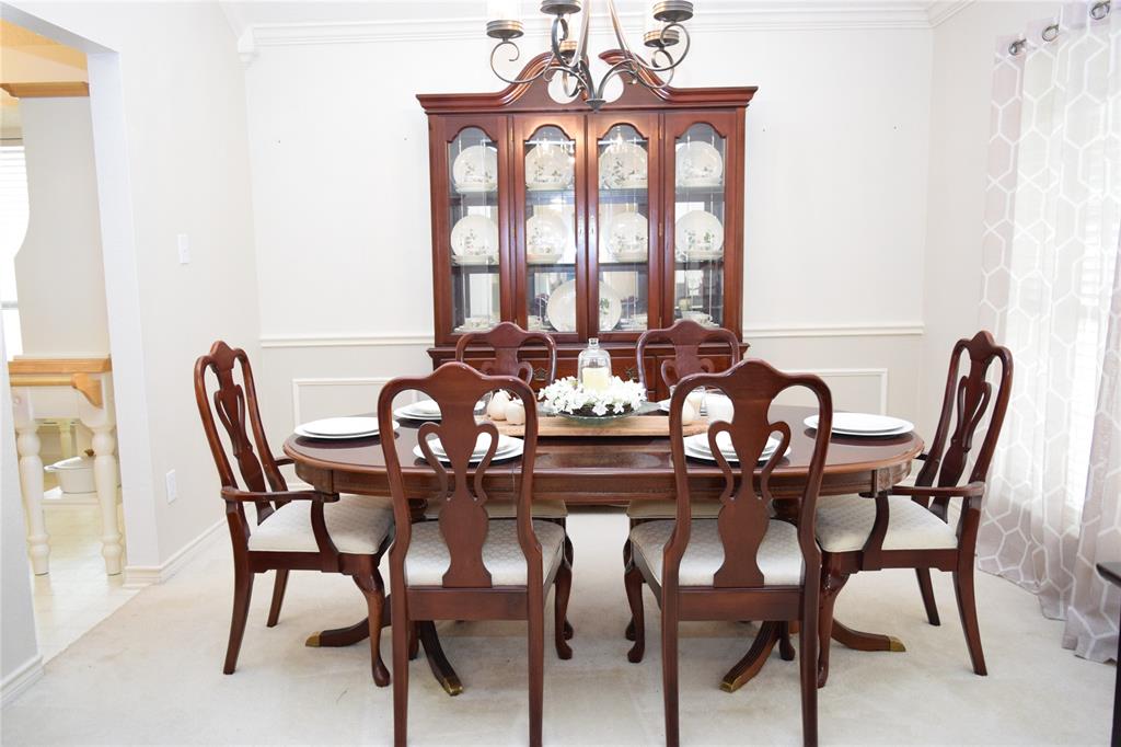 4201 Glistening Spring Rowlett, TX 75088 - Photo 13 of 33 Dining area featuring crown molding, chair rail, and wainscoting
