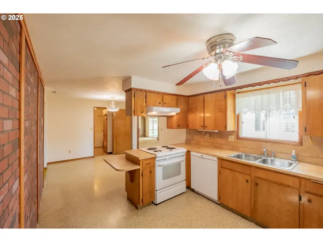 a kitchen with a stove a refrigerator and a sink
