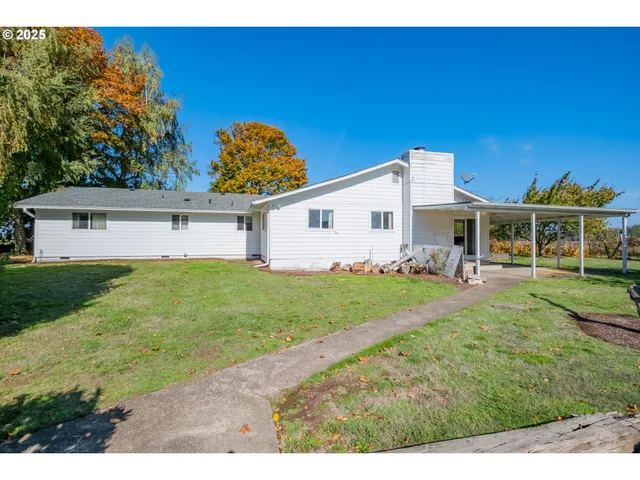 a view of backyard with seating area and green space