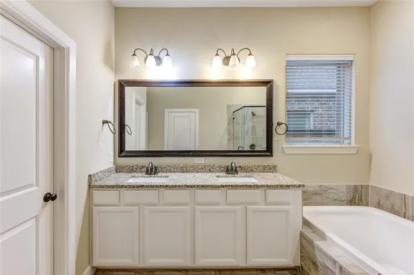 a bathroom with a bathtub and a shower