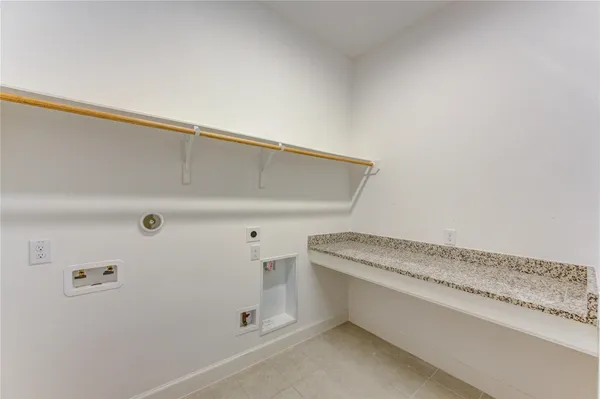 a bathroom with a granite countertop sink toilet mirror and bathtub