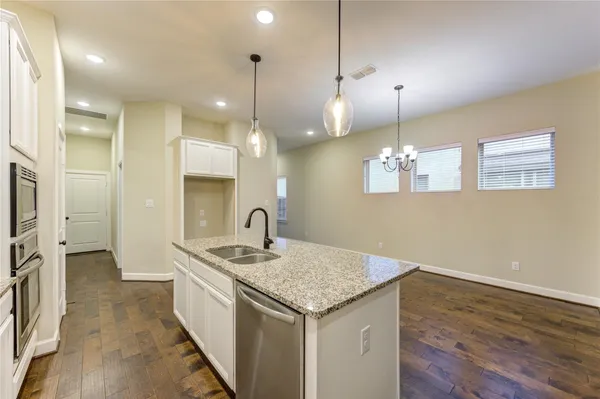 a kitchen with kitchen island a sink stainless steel appliances and cabinets