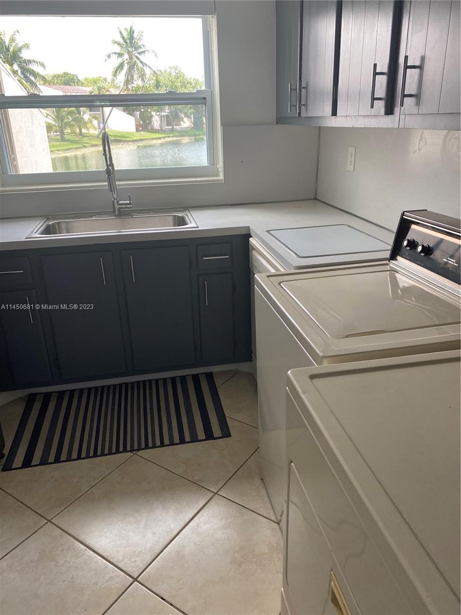 7262 Jacaranda Lane, Unit 7262 Miami Lakes, FL 33014 - Photo 5 of 9 a kitchen with a sink and cabinets