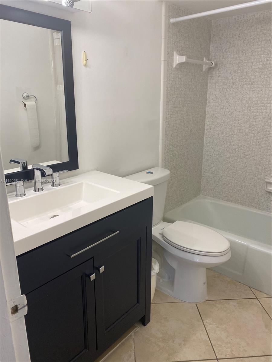 7262 Jacaranda Lane, Unit 7262 Miami Lakes, FL 33014 - Photo 8 of 9 a bathroom with a sink a toilet and shower