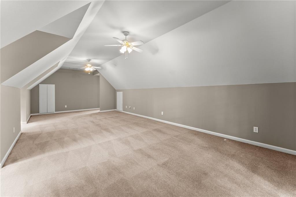 1040 Auburn Road Dacula, GA 30019 - Photo 34 of 42 en empty room with windows and fan