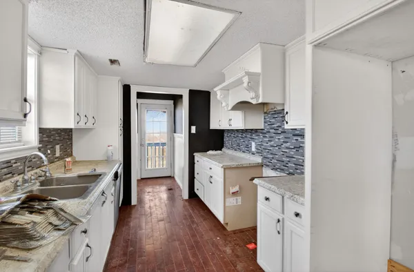 a kitchen with a stove oven and sink