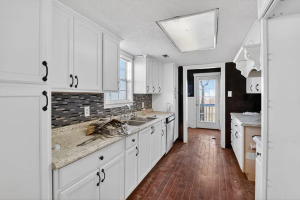 a large kitchen with a stove and a refrigerator