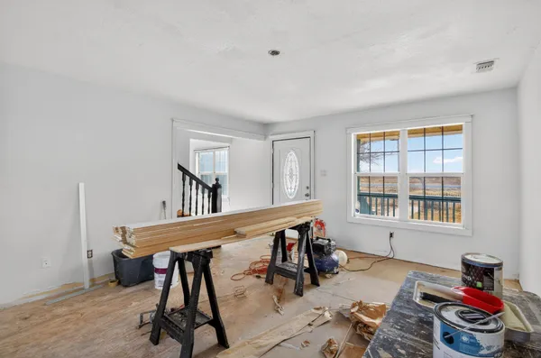 a livingroom with workspace and a window