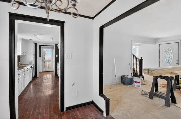 a view of hallway with livingroom and furniture