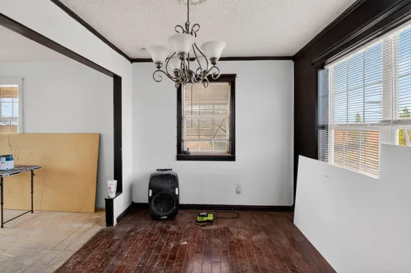 a view of a livingroom with a dishwasher wooden floor and a window