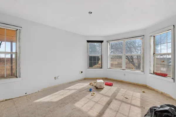 a bedroom with a bed and a large window