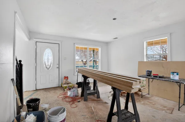 a room with furniture a rug and a window