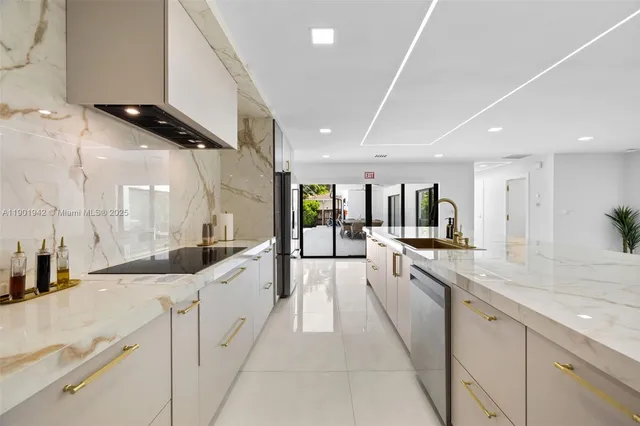 a kitchen with stainless steel appliances granite countertop a sink and cabinets