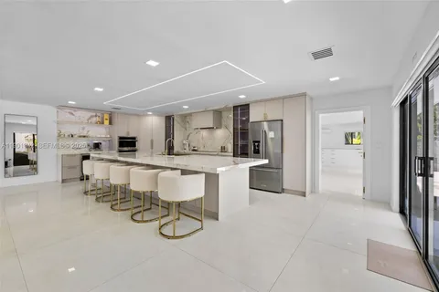 a kitchen with stainless steel appliances granite countertop a sink and cabinets