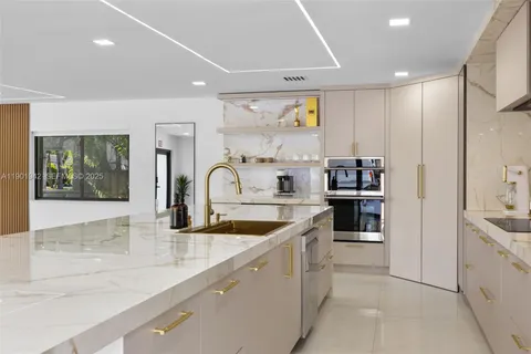 a large kitchen with a sink and cabinets