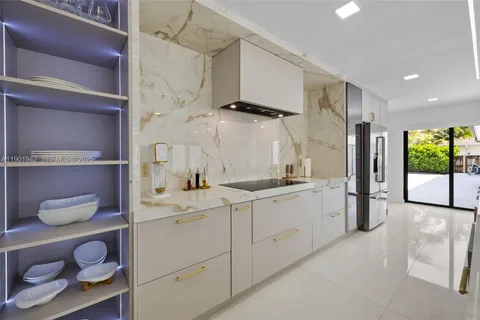 a kitchen with stainless steel appliances a sink and cabinets