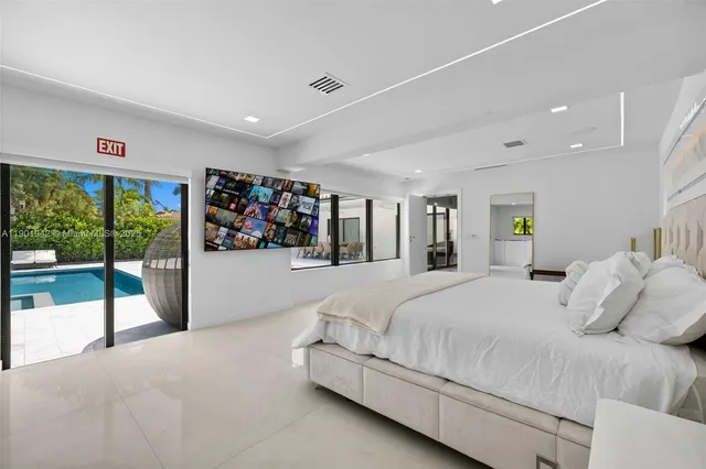 a view of a house with patio furniture and potted plants